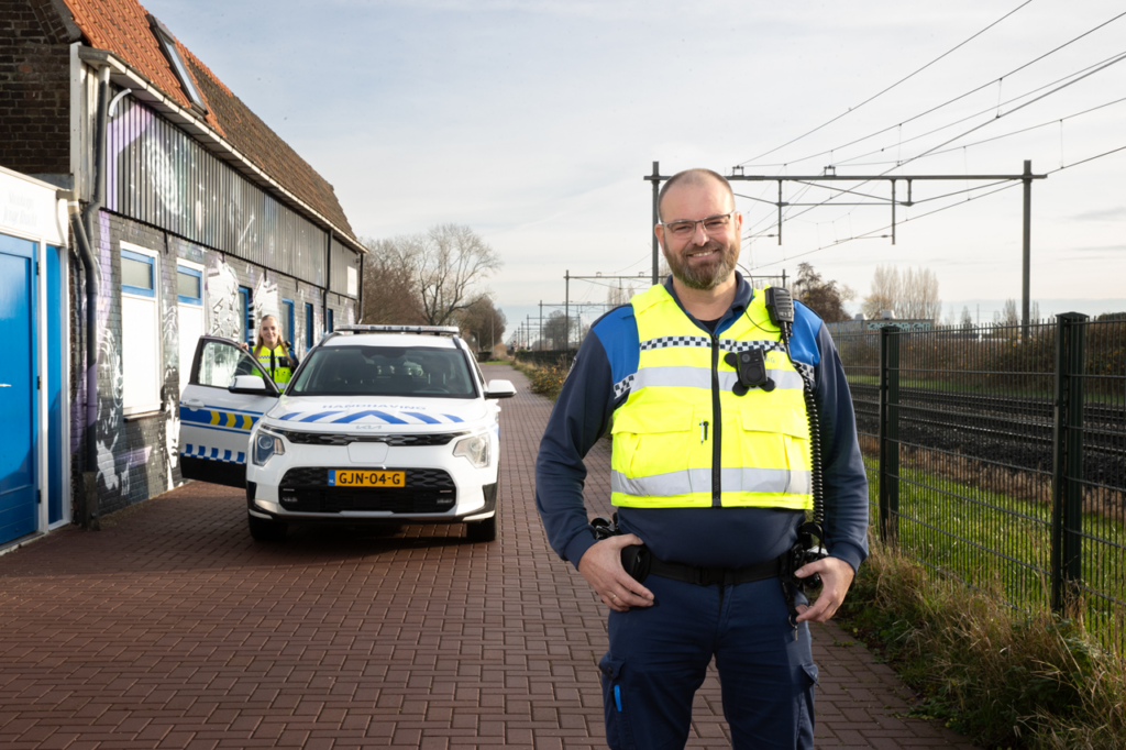 Boa met op de achtergrond zijn auto en daarnaast staat een collega boa.